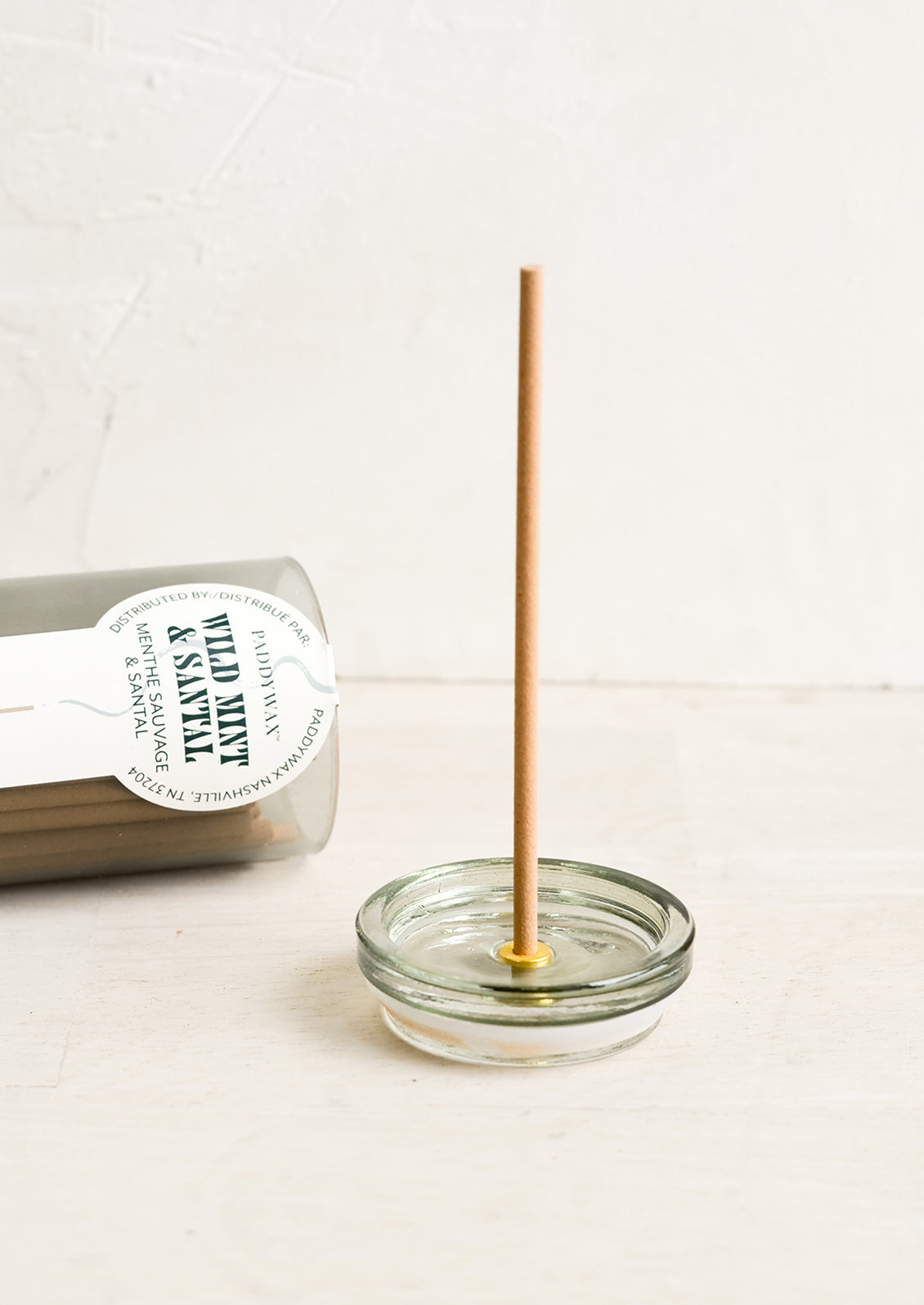 An incense jar with holder built into jar lid.