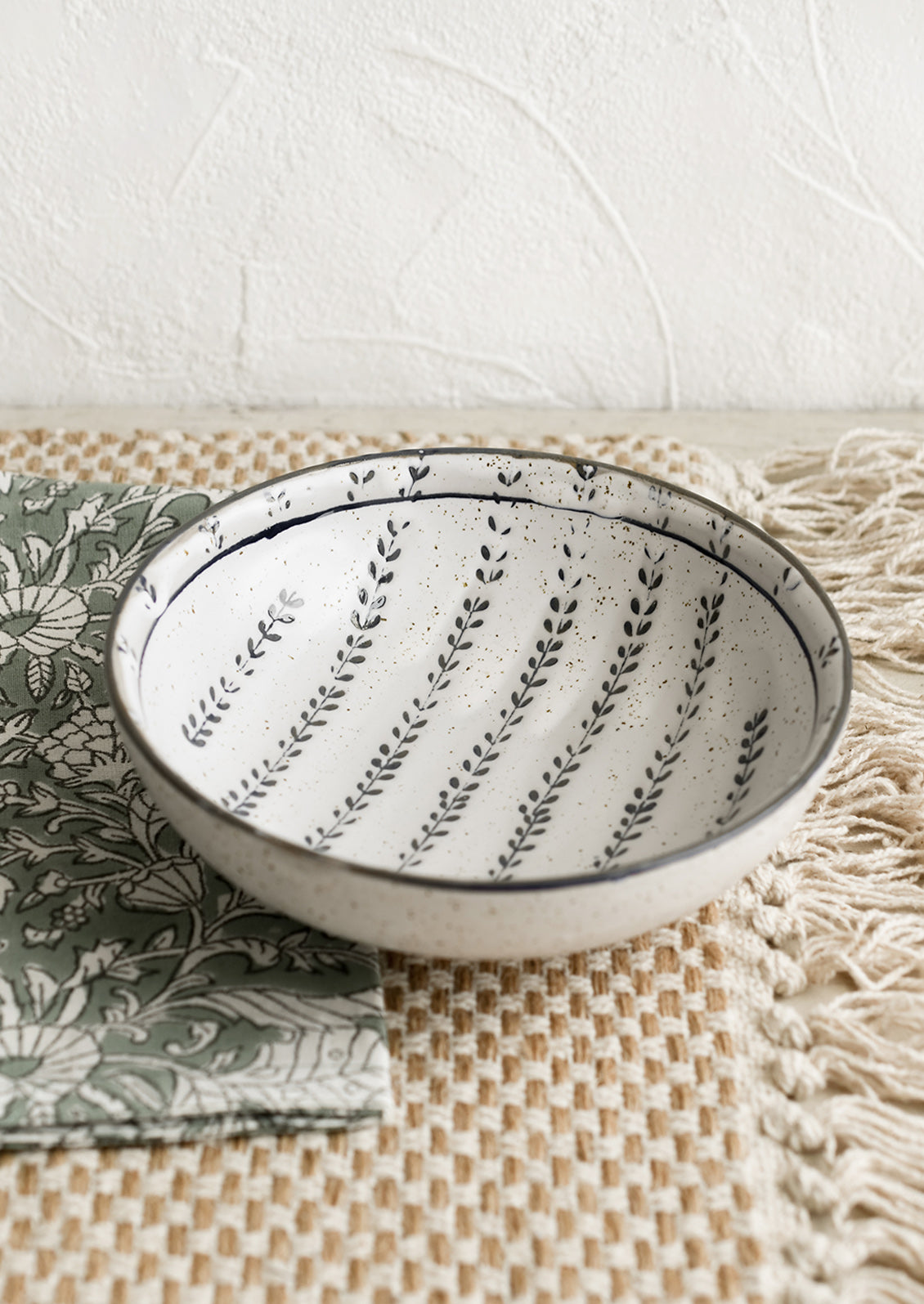 Tabletop setting with bowl, napkins and placemat.