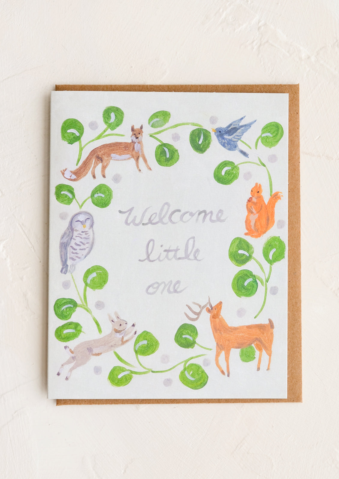 Card with illustration of woodland animals around text at center reading "Welcome little one".