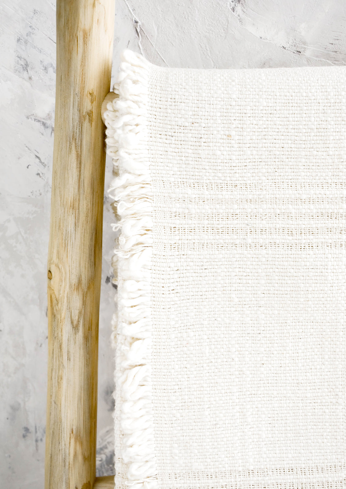 Throw made from undyed cotton with textural details