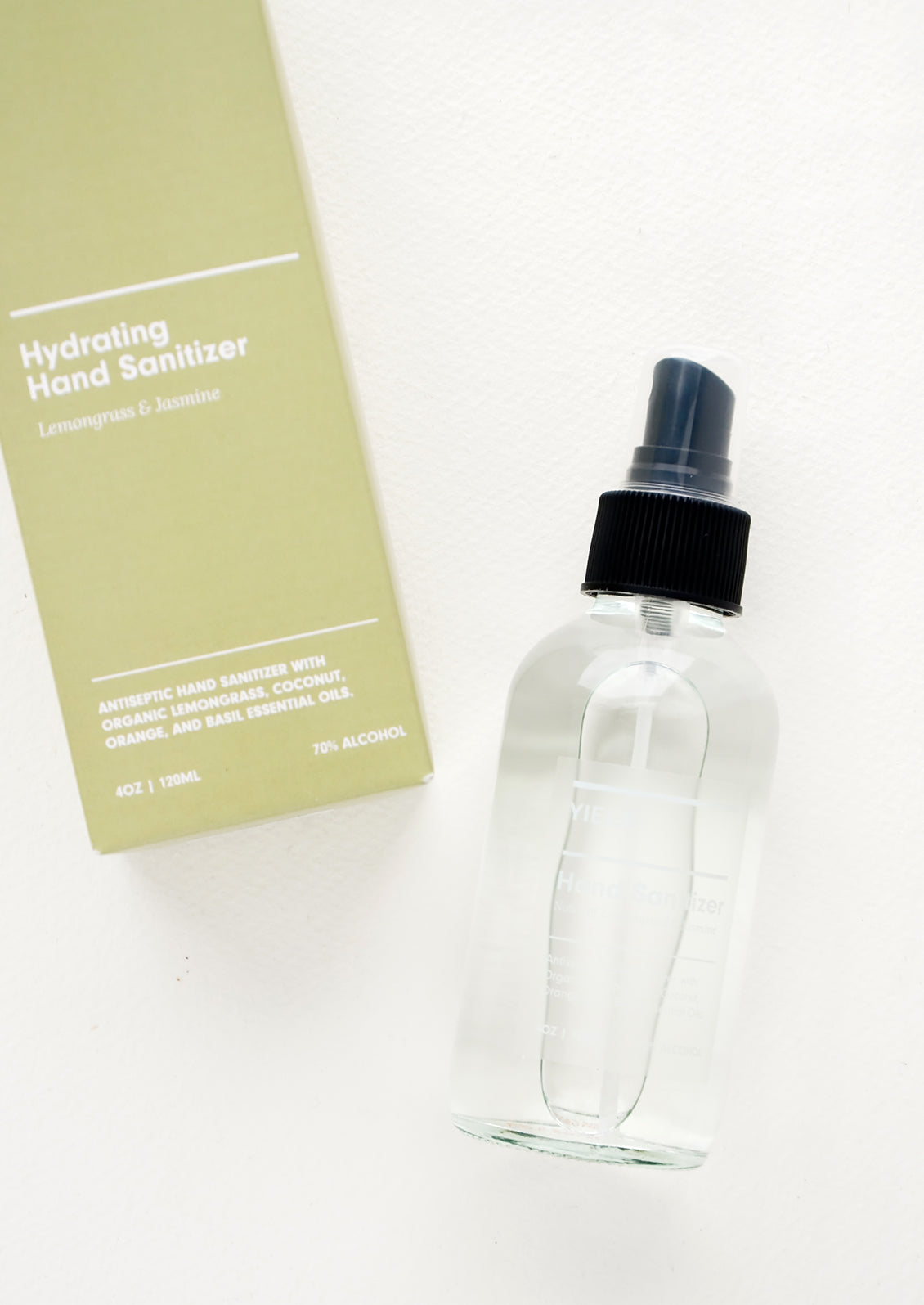 Green box packaging for hand sanitizer in clear glass spray bottle
